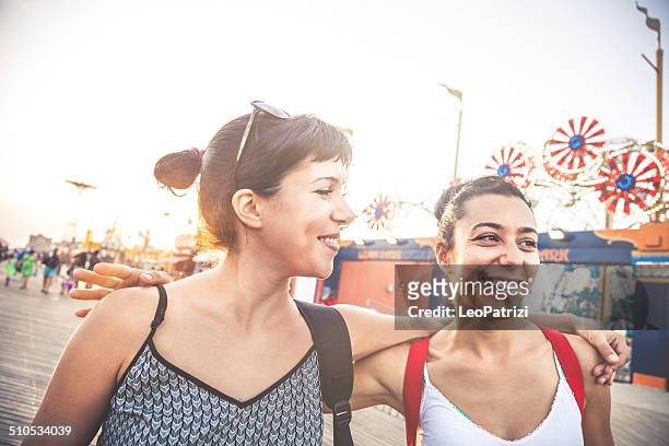 two friends at amusement park - luna park coney island stock pictures, royalty-free photos & images