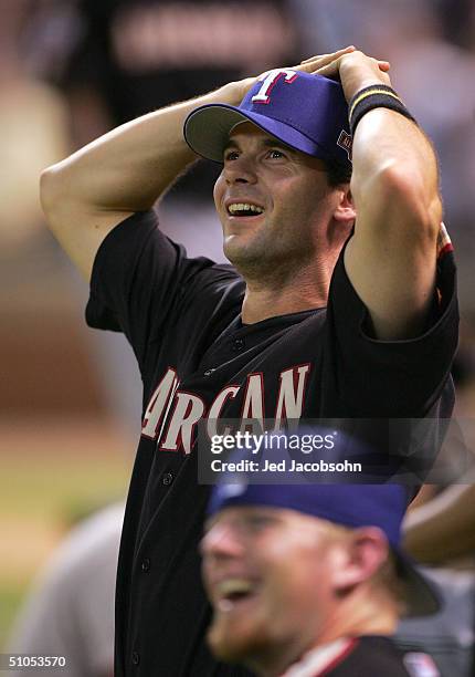 Michael Young of the American Team watches as Lance Berkman of the National Team hits in the Major League Baseball Century 21 Home Run Derby at...