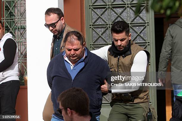 Policemen escort to the Alexandroupolis courthouse one of the three Britons arrested near the border with Turkey where they were suspected of heading...