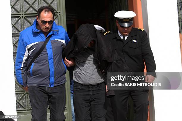 Policemen escort to the Alexandroupolis courthouse twp of the three Britons arrested near the border with Turkey where they were suspected of heading...