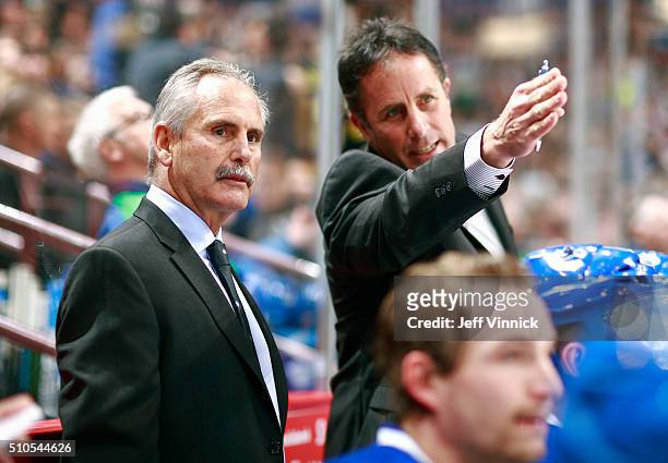 Head coach Willie Dejardins and assistant coach Doug Lidster of the Vancouver Canucks look on from the bench during their NHL game against the...