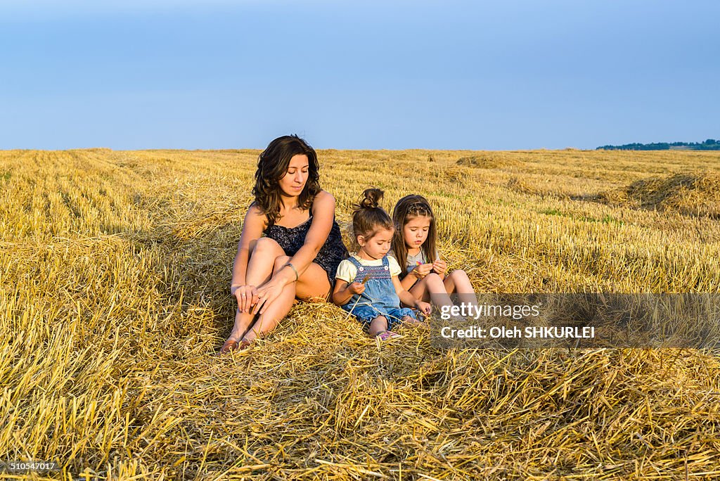 Family relaxing on hay