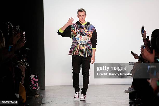 Designer Jeremy Scott greets the audience at the runway finale during the Jeremy Scott fashion show at The Arc, Skylight at Moynihan Station on...