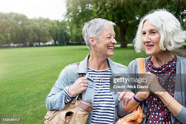 friends walking & laughing together - older woman short hair stock pictures, royalty-free photos & images