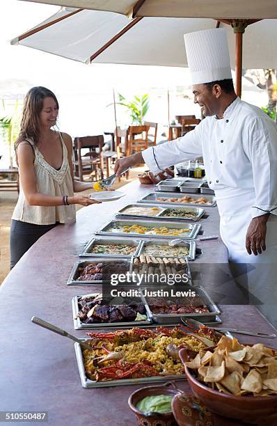 chef serving guest in outside buffet - long buffet line stock pictures, royalty-free photos & images