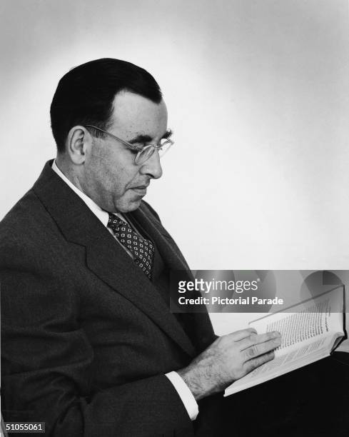 American sociologist, professor, and author David Riesman sits and reads a book, early 1950s.
