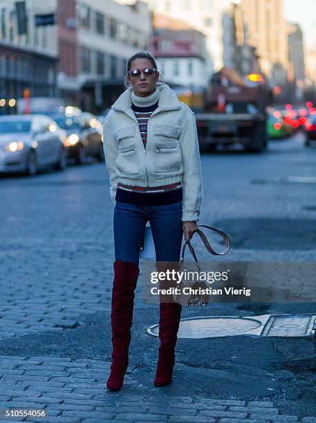 Helena Bordon is wearing By Helena Bordon sunglasses, DVF jacket, Tods bag and red Philosophy overknees seen outside Diane von Furstenberg during New...