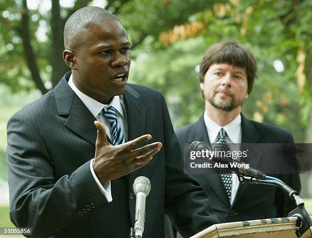 Boxer Vernon Forrest gestures as he speaks while documentary filmmaker Ken Burns looks on during a media conference to discuss a legal petition...