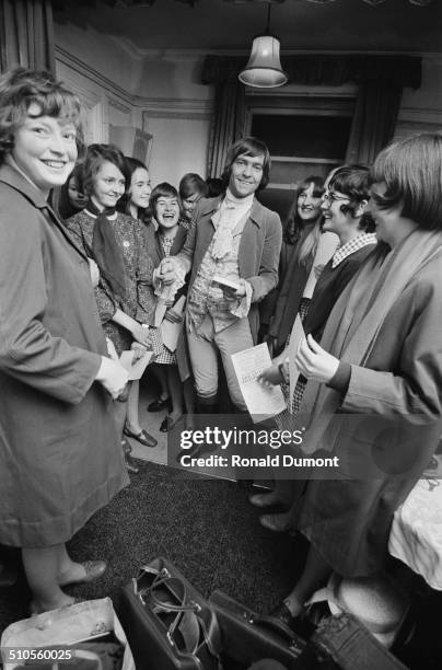 English actor Tom Courtenay is surrounded by autograph hunters in his dressing room, 22nd August 1969.