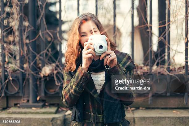woman taking photo with instant camera - girls flashing camera 個照片及圖片檔