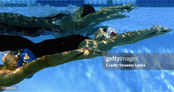 Margaret Hoelzer leads Hayley McGregory and Kristen Caverly as they swim underwater in the 200 meter backstroke final during the US Swimming Olympic...