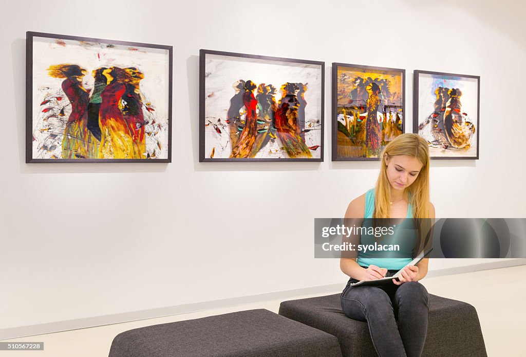 Young woman visits an art gallery