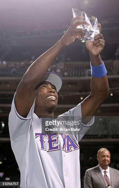 Alfonso Soriano of the American League team holds up his Ted Williams MVP trophy after defeating the National League team 9-4 in the Major League...