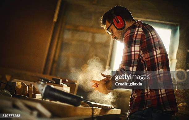 carpenter finishing work. - ear protection stock pictures, royalty-free photos & images