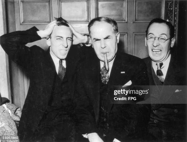 Three suited businessmen tear their hair out, 1934.