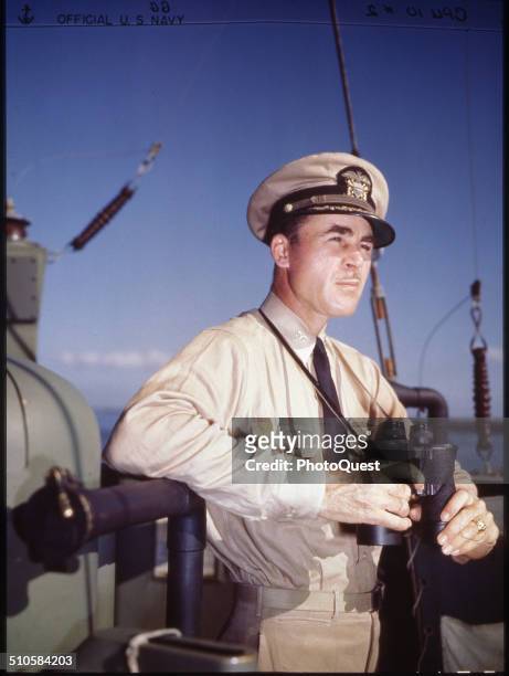 Capt Theodore Aylward, USN, acting commodore of Gunboat Support Group Task Force 52, on the bridge of his flagship, USS LCFF-988, during amphibious...