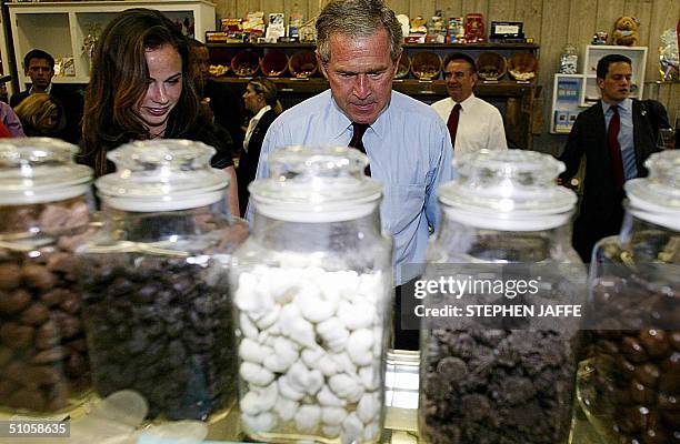 President George W. Bush and daughter Barbara shop 14 July during an impromptu stop on his bus campaign tour, at Mick's Candyman store in West Bend,...
