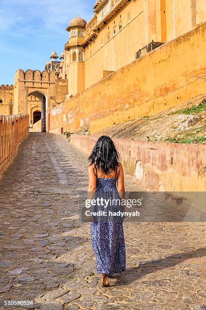 young indian woman on the way to amber fort, india - amer fort stock pictures, royalty-free photos & images