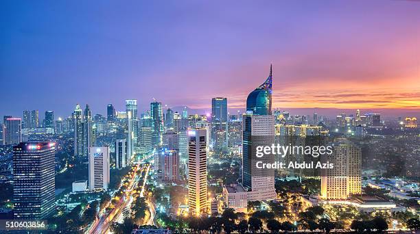 jakarta sunset - indonesia cityscape stockfoto's en -beelden