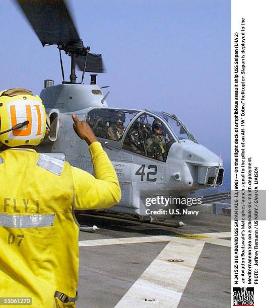 Jpg Aboard USS Saipan -- On The Flight Deck Of Amphibious Assault Ship USS Saipan An Aviation Boatswain's Mate Gives Launch Signal To The Pilot Of An...