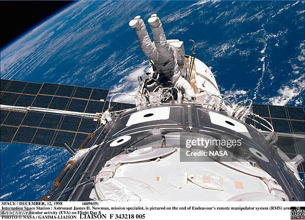Space / December 1998 Internation Space Station : Astronaut James H. Newman, Mission Specialist, Is Pictured On The End Of Endeavour's Remote...