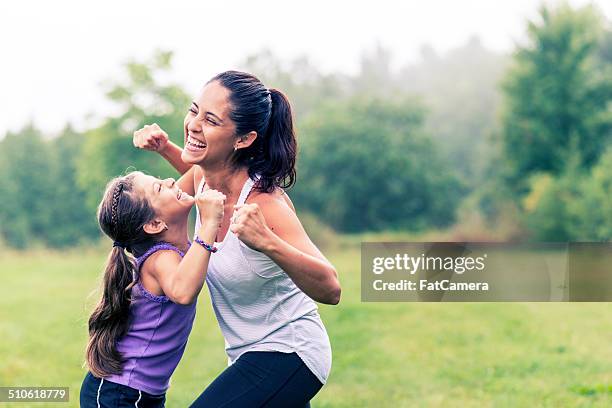 family fitness - hispanic mother child stock-fotos und bilder