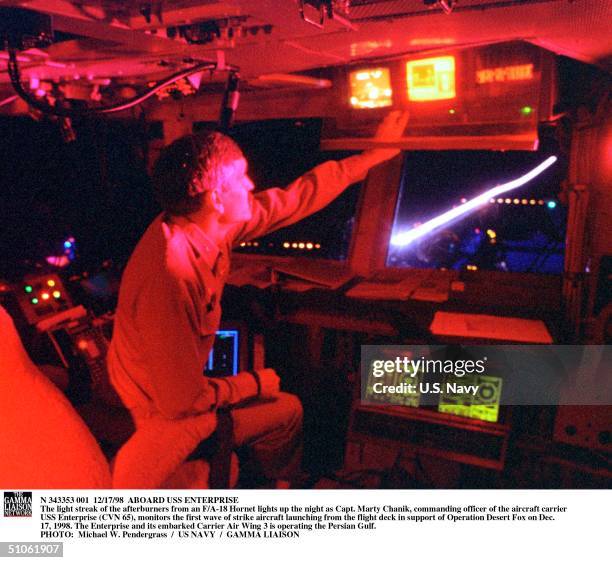 The Light Streak Of The Afterburners From An F/A-18 Hornet Lights Up The Night As Capt. Marty Chanik, Commanding Officer Of The Aircraft Carrier USS...