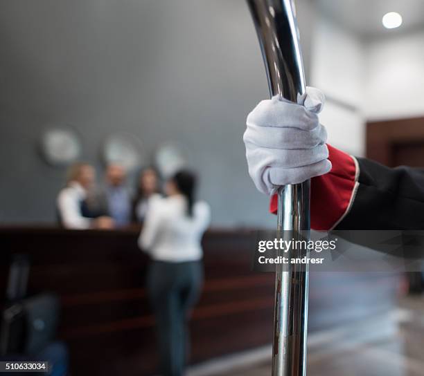 bellboy carrying bags at the hotel - bellhop stock pictures, royalty-free photos & images
