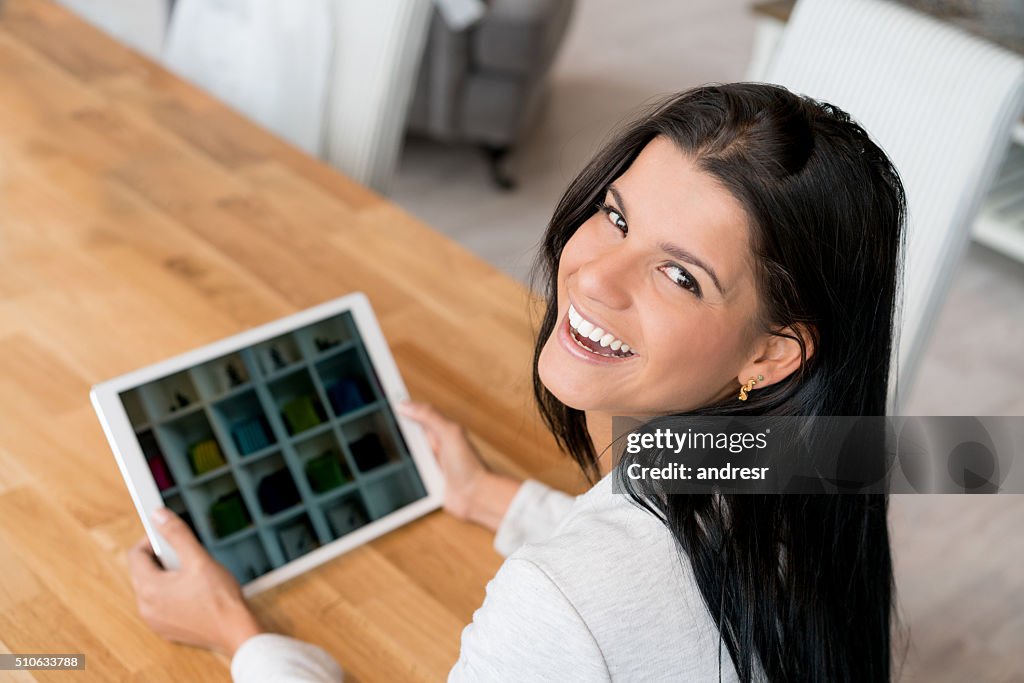 Happy woman shopping online on a tablet computer