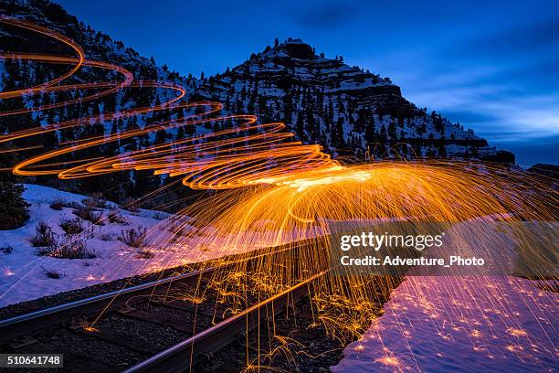 sparks and fire canyon landscape at dusk - brillos stockfoto's en -beelden