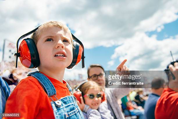 family at a car race - ear protection 個照片及圖片檔