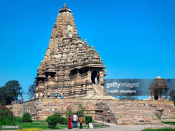 people visit the khajuraho group of monuments - khajuraho statues stock pictures, royalty-free photos & images