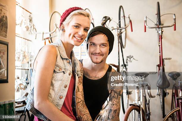 happy couple in a bike store - hipster couple bildbanksfoton och bilder