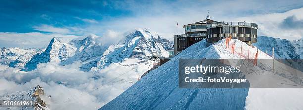 cable car station on snowy mountain idyllic winter peak panorama - grindelwald stock pictures, royalty-free photos & images