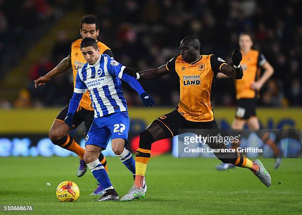 Anthony Knockaert of Brighton battles with Tom Huddlestone and Mo Diame of Hull City during the Sky Bet Championship match between Hull City and...
