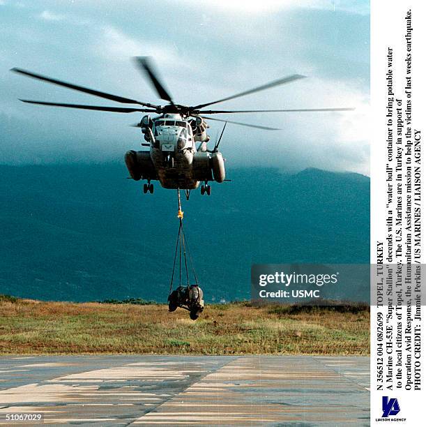 Topel, Turkey -- A Marine Ch-53E "Super Stallion" Decends With A "Water Bull" Container To Bring Potable Water To The Local Citizens Of Topel,...