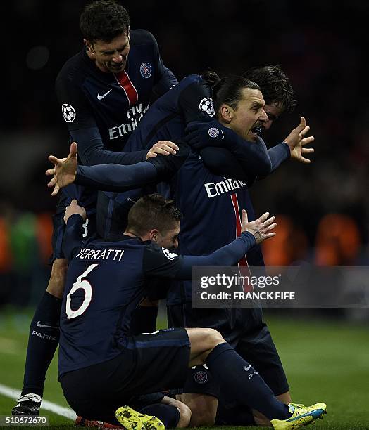 Paris Saint-Germain's Swedish forward Zlatan Ibrahimovic celebrates with teammates after scoring a goal during the Champions League round of 16 first...
