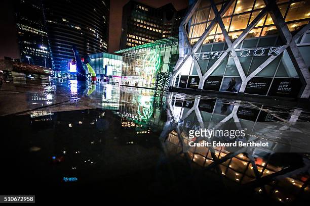 Shopping mall Les Quatre Temps and New Look shop reflecting into a puddle on February 13, 2016 in Paris La Defense, France.