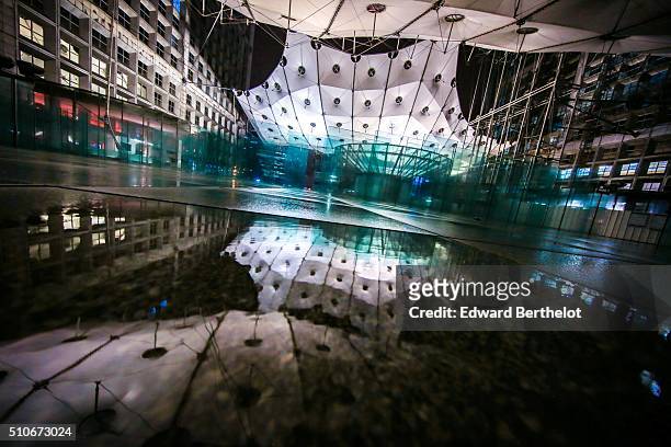 La Grande Arche de la Defense reflecting into a puddle on February 5, 2016 in Paris La Defense, France.