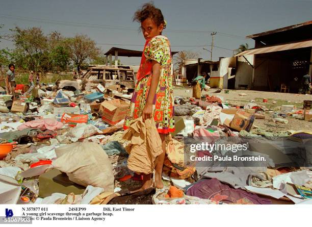 24Sep99 Dili, East Timor A Young Girl Scavenge Through A Garbage Heap.