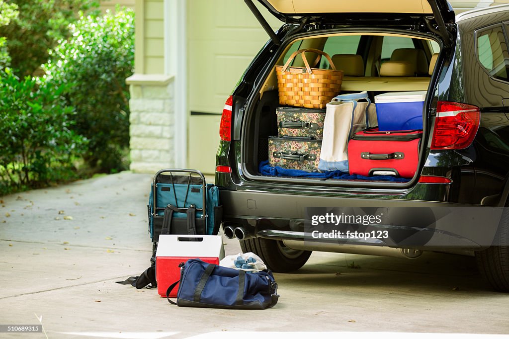 Family vehicle packed, ready for road trip, vacation outside home.