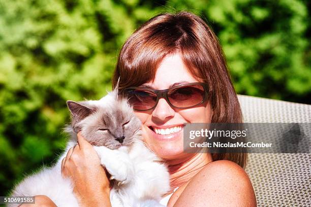 suburban woman portrait with her cat - hot housewives stock pictures, royalty-free photos & images