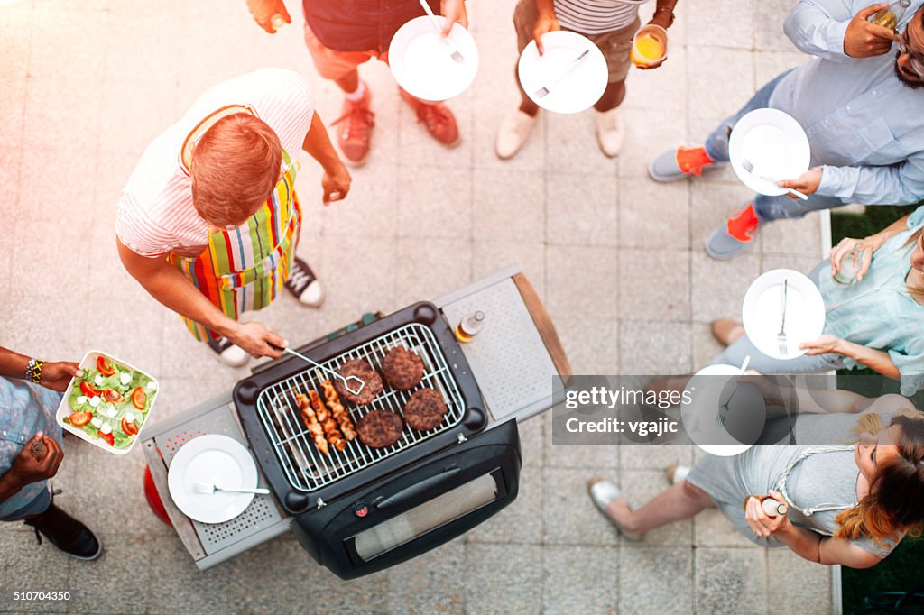 Young People Having Fun At Barbecue Party.