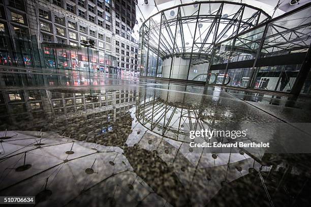 La Grande Arche de la Defense reflecting into a puddle on February 13, 2016 in Paris La Defense, France.