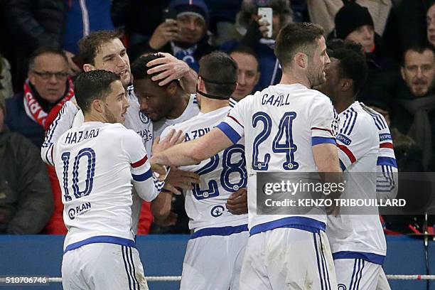 Chelsea's Nigerian midfielder John Obi Mikel celebrates with teammates after scoring a goal during the Champions League round of 16 first leg...