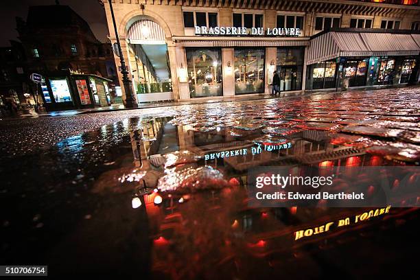 Brasserie du Louvre reflecting into a puddle on February 13, 2016 in the first quarter of Paris, France.