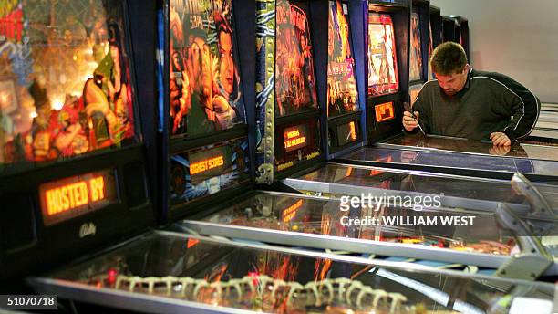 Pinball technician Owen Simons inspects some of the many pinball machines as part of Australia's biggest auction of the machines in Melbourne, 15...