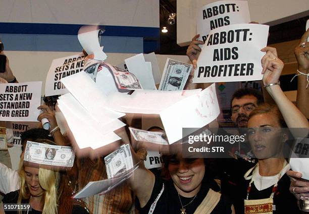 Activists throw fake US banknotes while shouting slogans against Abbott pharmaceutical company during the15th International AIDS Conference in...