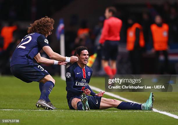 Edinson Cavani of Paris Saint-Germain celebrates with team mate David Luiz as he scores their second goal during the UEFA Champions League round of...