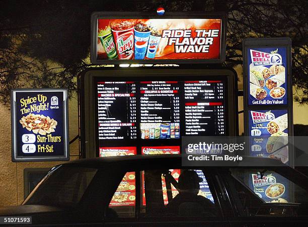 Driver places a drive-up order at a Taco Bell fast-food restaurant July 15, 2004 in Mount Prospect, Illinois. Fast-food restaurant chains are...